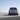 Три изгледа отзад на новия Hyundai IONIQ 9, паркиран на фона на слънчево небе.