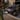 Woman walking past IONIQ 6 whilst plugged into home charger.